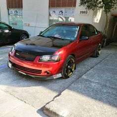 a red car parked in front of a building