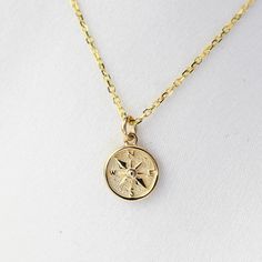 "14K Gold North Star Charm Necklace. 14k gold compass necklace, Graduation gift, Travel necklace This necklace is adjustable to 16\", 17\" or 18\" lengths.  ★ The necklace is 14K solid gold.  ★ 14K gold North Star Charm is tiny, it is about 7mm." Second Star Necklace, Gold Compass Design Necklace For Travel, Yellow Gold Charm Necklace With Compass Design, Yellow Gold Compass Design Charm Necklace, 14k Gold Compass Design Round Pendant Necklace, Gold Minimalist Compass Design Jewelry, Minimalist Gold Compass Design Jewelry, Gold Compass Necklace, Secret Message Bracelet