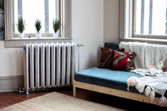 a living room with a couch, rug and radiator