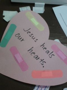 a piece of paper that says jesus heals our heart on top of other pieces of paper