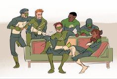 a group of people dressed in green are sitting on a couch