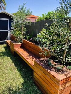 a wooden bench sitting in the middle of a garden