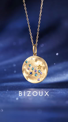 the zodiac sign is displayed on a gold plated necklace with swarong crystals