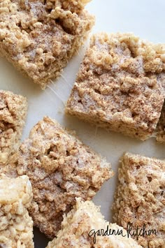 several pieces of cake sitting on top of a white tablecloth covered in powdered sugar