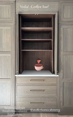 a wooden cabinet with two drawers and a bowl in it that says volta coffee bar