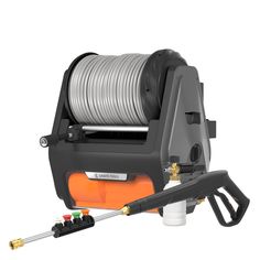 an orange and black hose is hooked up to a spooling machine with wire on it