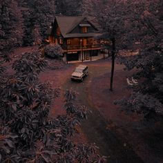 a car parked in front of a house surrounded by trees