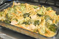 a casserole dish with broccoli and chicken in it on the stove