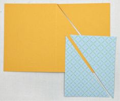 a piece of yellow paper with a pair of scissors next to it