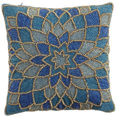 a blue and gold decorative pillow with beading on it's sides, in the shape of a flower