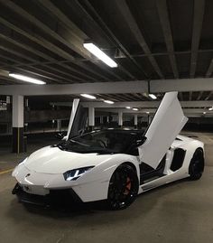 a white sports car parked in a parking garage