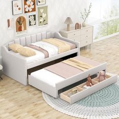 a white bed sitting on top of a wooden floor