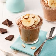 two bowls filled with oatmeal topped with banana slices and sliced almonds