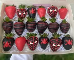 chocolate covered strawberries in a box with spider web decorations on the top and bottom