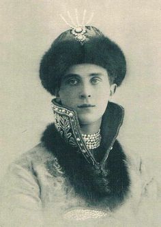 an old black and white photo of a woman wearing a hat with feathers on it