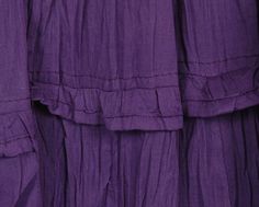 purple dress with tiered ruffles on the front and bottom, close up