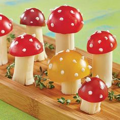 a group of small mushrooms sitting on top of a wooden table next to each other