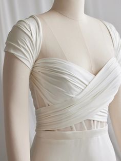 the back of a white dress on a mannequin