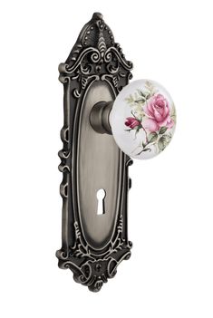 an antique style door handle with pink roses on the front and back of it,