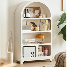 a white book shelf with books and magazines on it