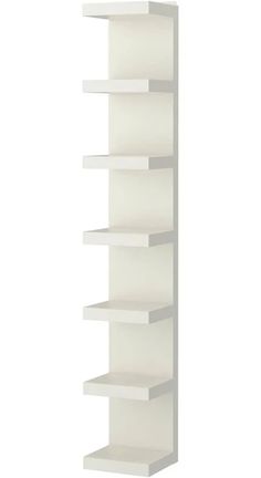 a white book shelf with five shelves on each side