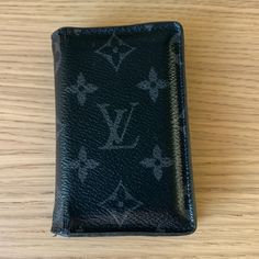 Men’s Louis Vuitton Wallet Pocket Organizer Grey Monogram Eclipse Canvas Pre-Loved, Worn, Minor Cracking On Binding Comes With Bag, Box, And Receipt Purchased In 2018 2.8 X 4.3 X 0.4 Inches (Length X Height X Width) Coated Canvas Cowhide Leather Lining 5 Interior Pockets 1 Exterior Pocket 3 Credit Cards Slots Cowhide Leather Lining Louis Vuitton Black, Pocket Organizer, Louis Vuitton Wallet, Credit Cards, Cowhide Leather, Louis Vuitton Bag, Binding, Slots, Credit Card