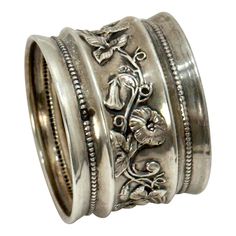 two silver rings with flowers and leaves on them