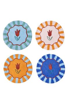 four coasters with flowers on them in different colors and designs, one is blue, the other is orange