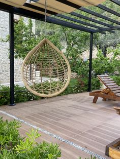 a hanging chair in the middle of a patio