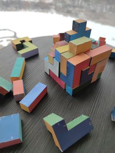 several pieces of colored cardboard sitting on top of a wooden table next to each other