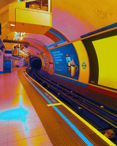 a train traveling through a tunnel filled with lots of bright colored lights on the ceiling