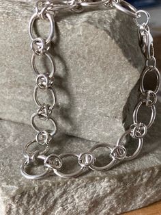 A Modern chunky Silver oval link bracelet,    oval links 12mm x 10mm with a decorative wire connecting link , silver trigger  fastener, 19cm  long , 925 Silver Sterling Silver Bracelets With Chunky Chain In Oval Link, Silver Oval Link Chain Bracelet, Modern Sterling Silver Bracelet With Rolo Chain, Silver Oval Link Chunky Chain Bracelet, Modern Silver Charm Bracelet With Rectangular Links, Silver Oval Link Charm Bracelet, Silver Bracelet With Oval Link Rolo Chain, Silver Bracelet With Rolo Chain Oval Link, Silver Chunky Chain Round Bracelet