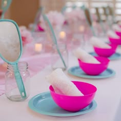 pink and blue dishes are lined up on the table