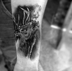 a black and white photo of a deer with antlers on its head tattoo design