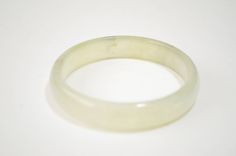 "Beautiful vintage estate icy green jadeite jade bangle. It is in very good vintage condition with natural stone lines, measures 7.25\" long, 60 mm of inside diameter, 14 mm wide, weighs 42 grams. Shipping & Handling: We usually ship within 1 business day. If you have any questions about this item, please contact us for more details. I do offer international shipping, but please message me first before purchasing so I can make a separate listing for you! S4" Vintage Jade Round Bracelets, Vintage Round Jade Bracelets, Vintage Jade Bracelets, Jade Bangle Bracelet, Jade Bangle, Bangle Bracelet, Natural Stone, Natural Stones, Bangle Bracelets