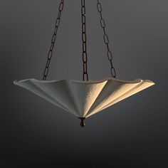 a light fixture hanging from a chain in the dark