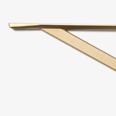 a gold tie bar on a white background