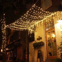 a building that has some lights hanging from it's roof and on the side