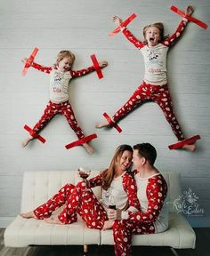 two people in matching pajamas are sitting on a couch