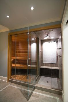 a bathroom with a glass enclosed sauna