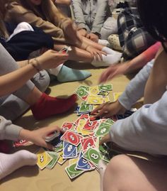 people sitting on the floor playing with letters and numbers