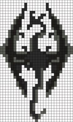 a cross stitch pattern in black and white with the shape of a skull on it