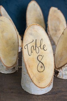 wood slices with the word table and written on them are sitting on top of each other