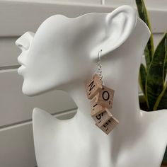 a white mannequin head with wooden letters on it