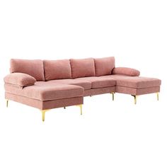 a pink sectional sofa with gold legs and footrests on an isolated white background