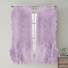 a window with purple ruffled curtains hanging from it's side and a plant on the other side