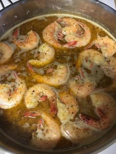 the shrimp is being cooked in the pot on the stove top, ready to be eaten