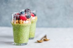 two glasses filled with food sitting on top of a table