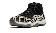 The Women’s Air Jordan 11 “Animal Instinct” is a women’s-exclusive colorway of the vintage basketball shoe with three different animal-inspired patterns on its luxurious design.  A Holiday 2021 release by Jordan Brand, the “Animal Instinct” is one of the boldest colorways of Michael Jordan’s eleventh signature shoe ever produced by Jordan Brand.  The look, which borrows stealthy, black-based design elements from the shoe’s “Cap and Gown” colorway, is complete with a black leather upper with a faux fur mudguard that features a mixture of cheetah, zebra, and leopard prints.  A matte black Jumpman appears on the collar and red “23” branding is found on the heel.  Classic red-based “Jumpman” detailing graces the black nylon tongue.  A white foam midsole and translucent black outsole complete t Jordan Retro 11, Animal Instinct, Nike Air Jordan 11, Retro 11, Womens Air Jordans, Air Jordan 11 Retro, Air Jordan Retro, Jordans Women, Air Jordan Sneakers