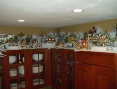 a kitchen with wooden cabinets and christmas decorations on the wall